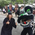 Sam with dragon at graduation